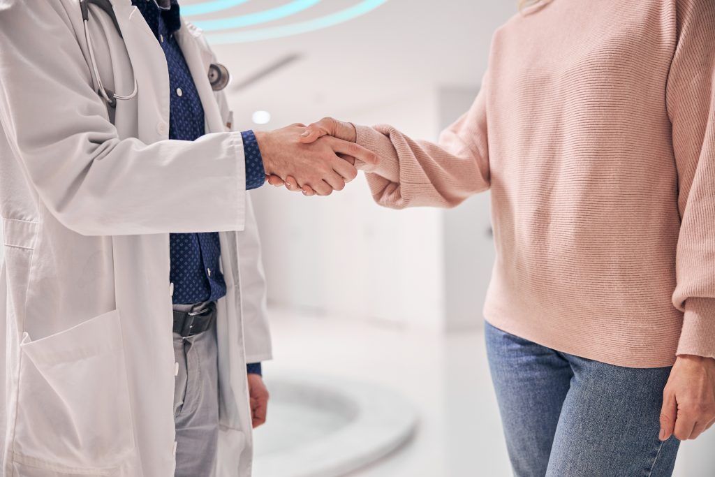 Doctor greeting his patient with a handshake
